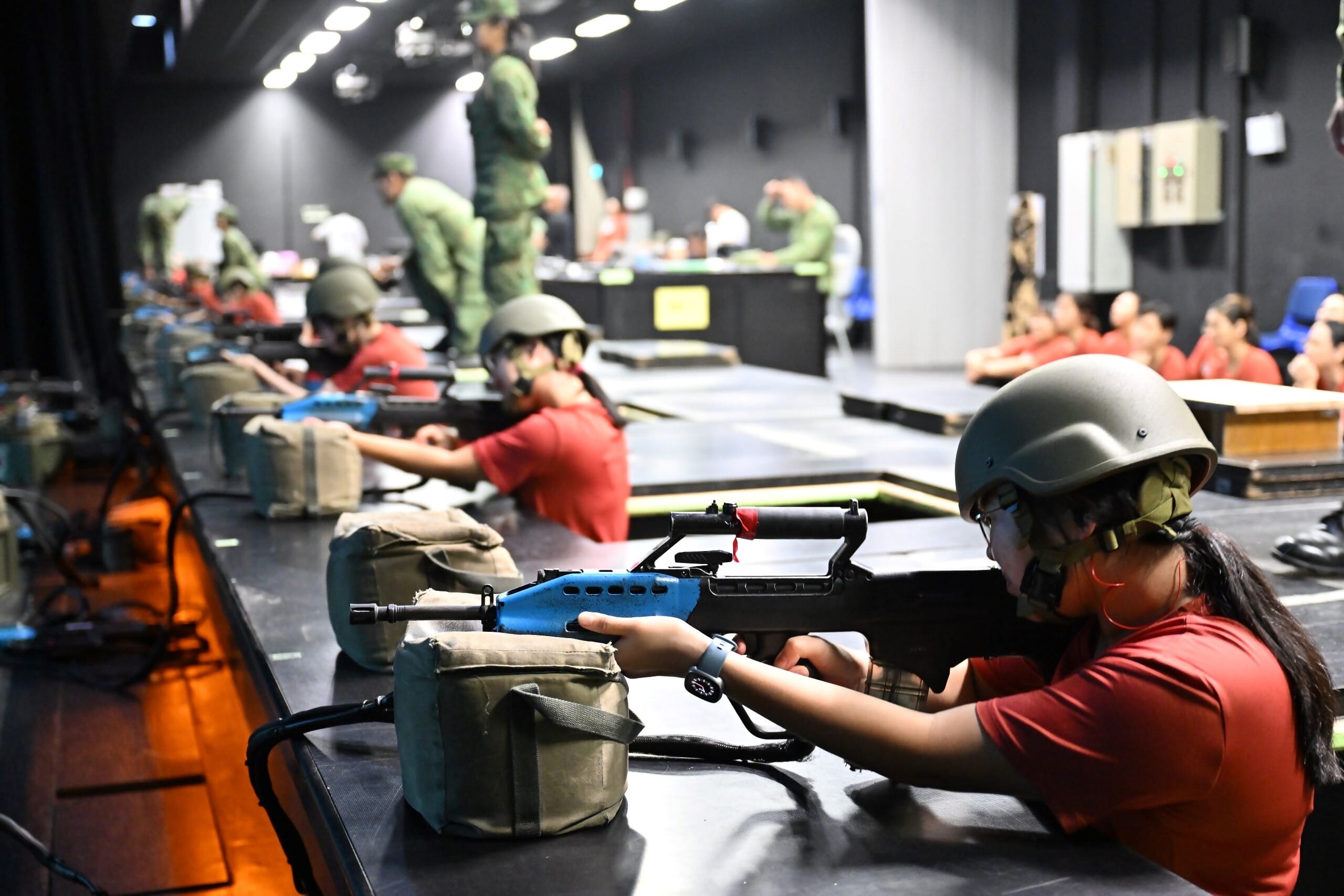 WBC25 participants having a hands-on experience with the SAR 21 at the Individual Markmanship Trainer (IMT) range.